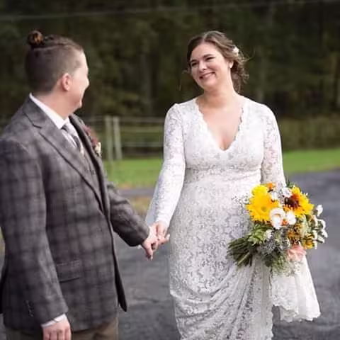 Couple hold hands looking at each other